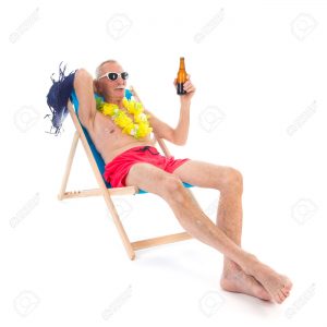 Retired man on vacation sitting in beach chair drinking beer